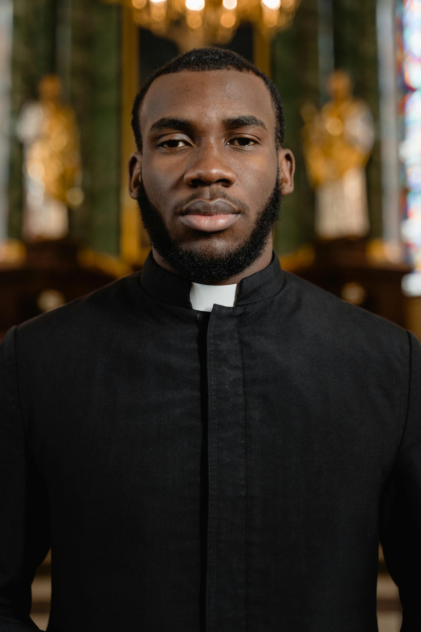 Close-up portrait of an African American priest in a church setting, highlighting faith and spirituality.